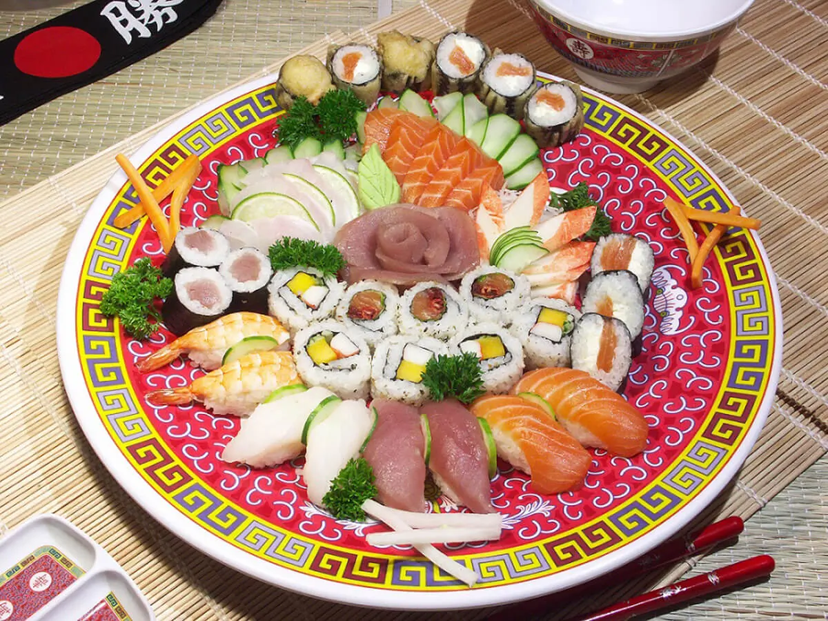 Sushi and Sashimi Combination Platter presents a variety of sushi rolls and sashimi, neatly arranged on a large decorative plate at Sumo Sushi Hibachi, a Japanese restaurant in Daytona Beach